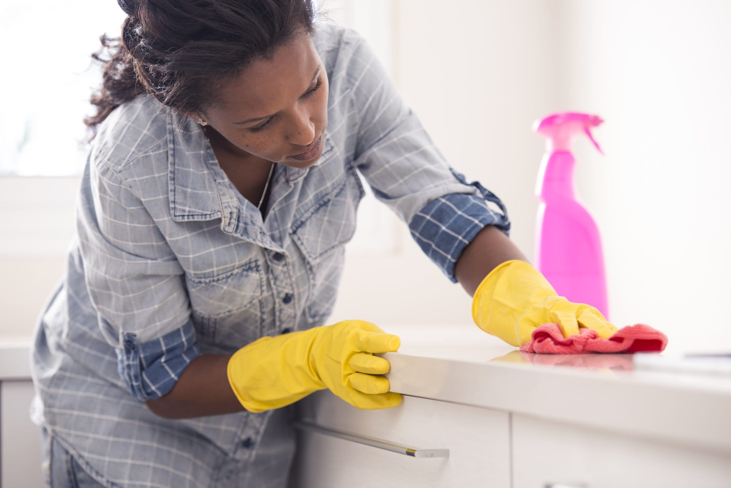 Woman cleaning kitchen worktop. | Charlotte Cleaning Service ...